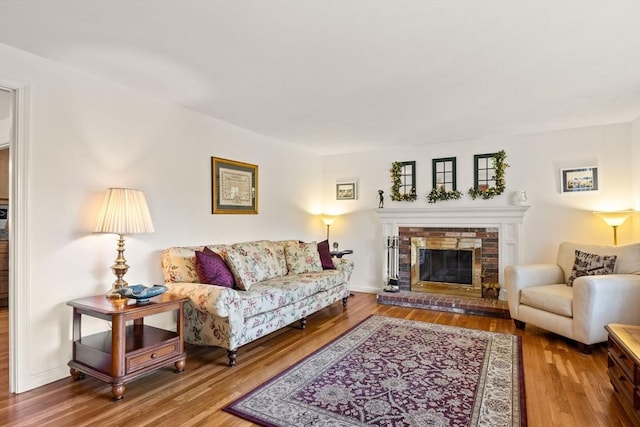 54 Mcnamara Ave, Yarmouth, MA 02673 - living area with wood finished floors and a brick fireplace