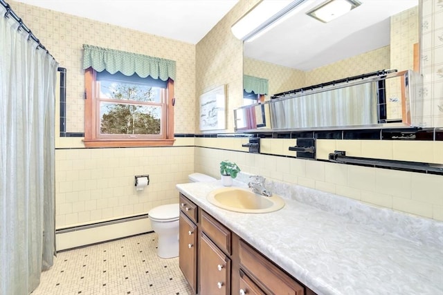 bathroom with a baseboard radiator, toilet, tile walls, and vanity