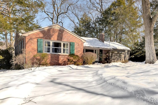 view of front of house featuring brick siding and a chimney