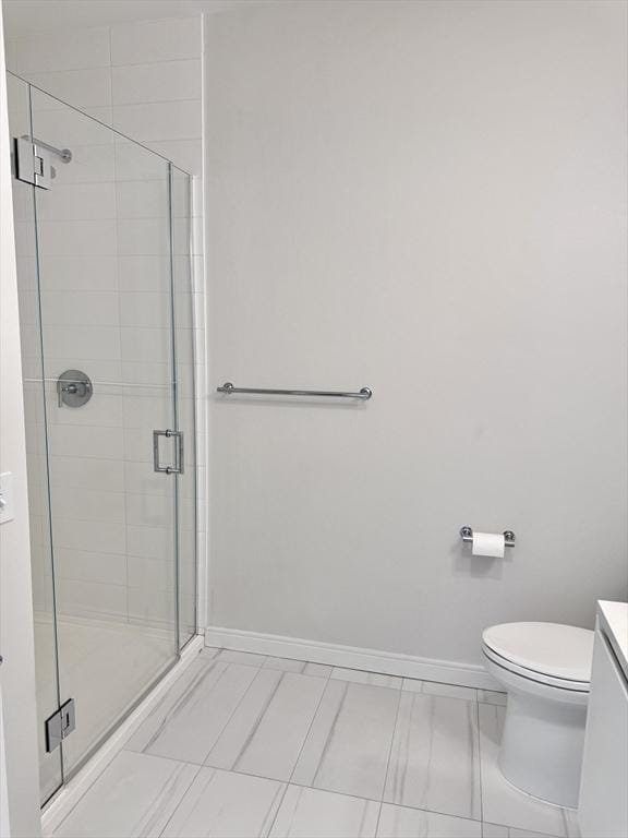 191 Washington St Unit 708, Boston, MA 02135 - bathroom featuring vanity, baseboards, a stall shower, and toilet