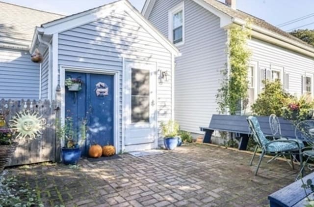 rear view of house featuring a patio and a chimney