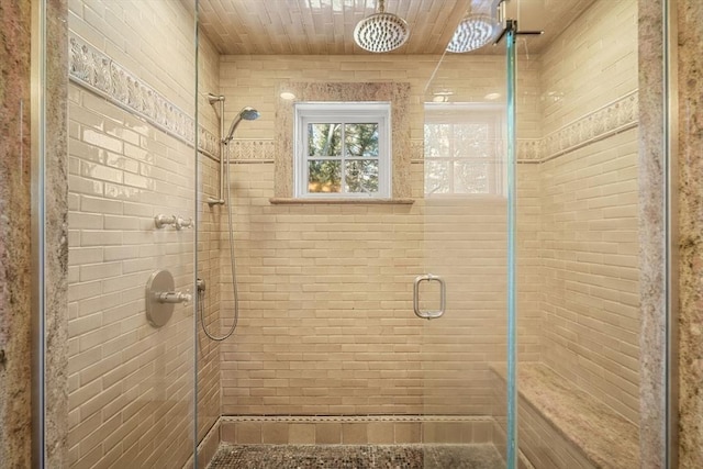 bathroom with a shower with door