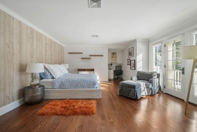 bedroom featuring dark hardwood / wood-style flooring, access to outside, and ornamental molding