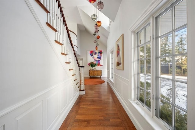 hallway with dark hardwood / wood-style flooring and vaulted ceiling