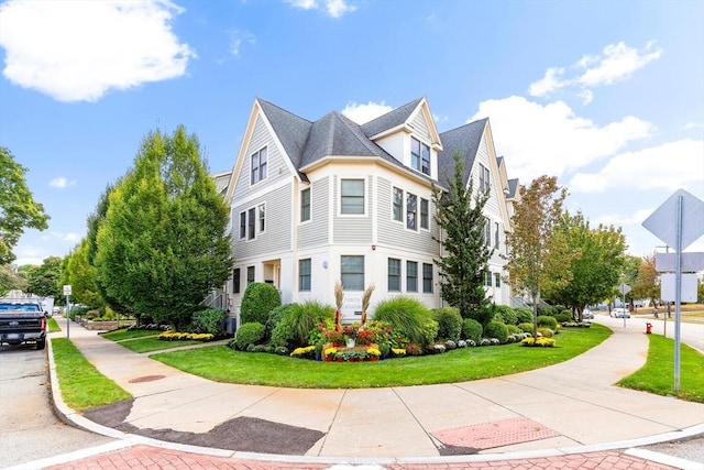 view of side of home with a yard