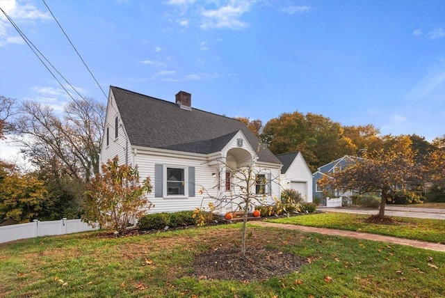 new england style home featuring a front yard and a garage