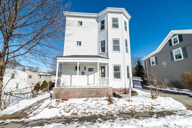 view of front of house with a porch and fence