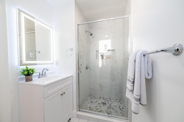 full bath with vanity and a marble finish shower