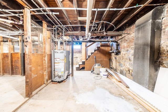 basement featuring water heater and stairway