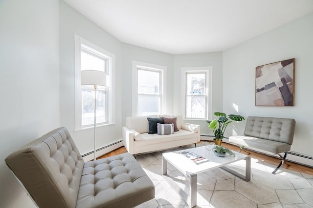 living room with baseboard heating and wood finished floors