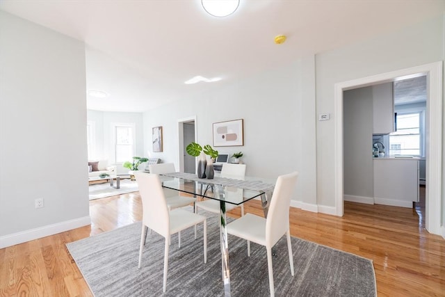 dining area with wood finished floors and baseboards