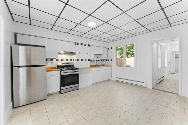 212 Princeton St Unit 1, Boston, MA 02128 - kitchen featuring a baseboard radiator, butcher block counters, under cabinet range hood, and stainless steel appliances
