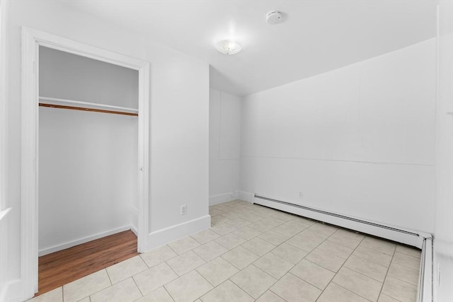 212 Princeton St Unit 1, Boston, MA 02128 - unfurnished bedroom with a closet, baseboards, light tile patterned flooring, and baseboard heating