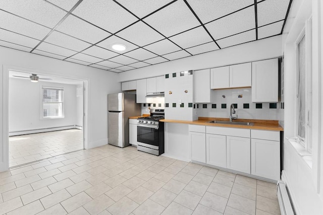 212 Princeton St Unit 1, Boston, MA 02128 - kitchen featuring baseboard heating, a sink, wooden counters, stainless steel appliances, and a baseboard heating unit