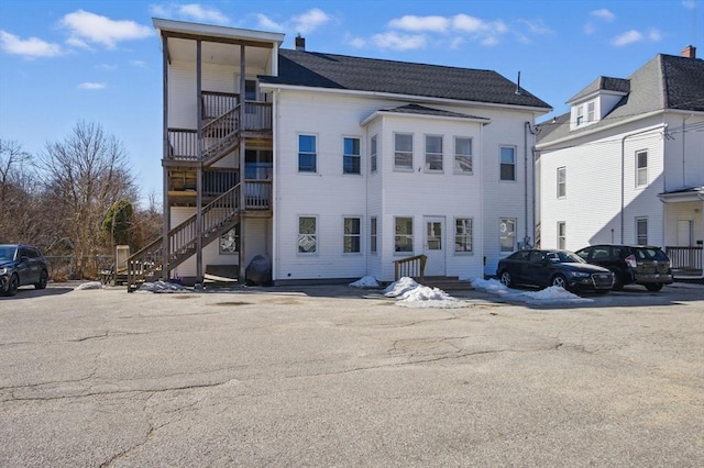 exterior space with uncovered parking and stairway