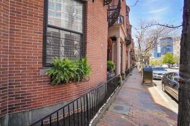 view of property exterior featuring brick siding