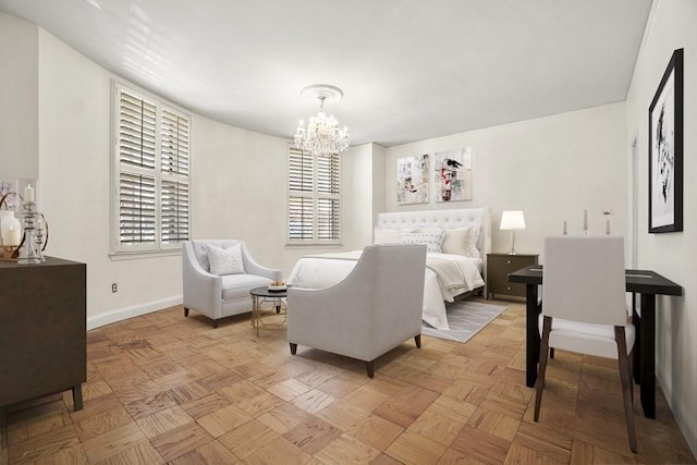 bedroom featuring baseboards, multiple windows, and an inviting chandelier