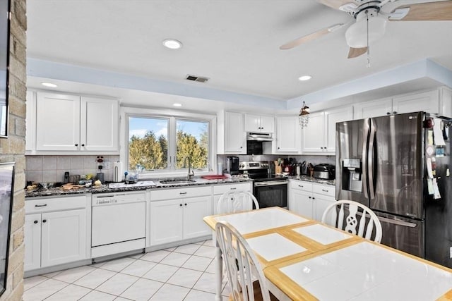 kitchen with white cabinetry, sink, stainless steel appliances, tasteful backsplash, and light tile patterned flooring