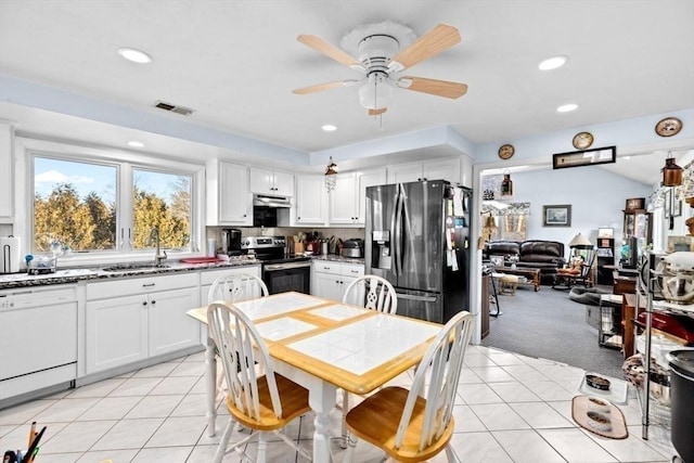 kitchen with light carpet, sink, ceiling fan, white cabinetry, and stainless steel appliances