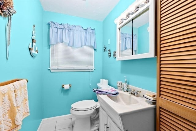 bathroom featuring tile patterned flooring, vanity, and toilet