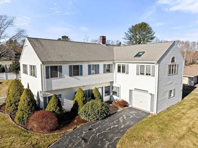 view of front of property with a garage and a front yard