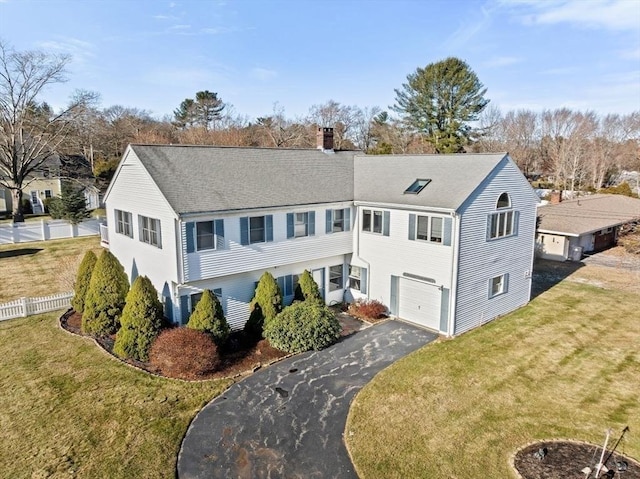 view of front of home with a front lawn and a garage