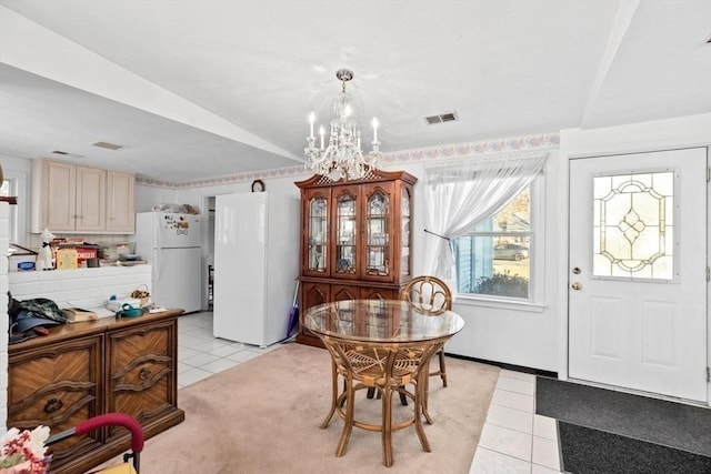 tiled dining room featuring a chandelier