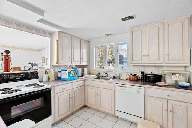 kitchen featuring dishwasher, electric range, tasteful backsplash, and sink