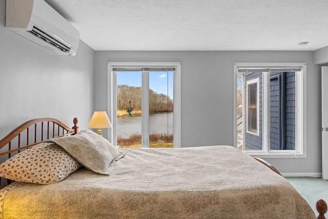 bedroom featuring baseboards, carpet, an AC wall unit, and access to exterior