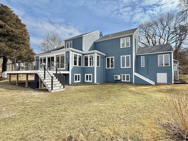 rear view of property featuring central air condition unit, stairway, a yard, and a wooden deck