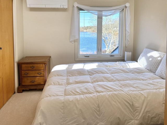 bedroom with multiple windows, carpet floors, and a wall mounted AC