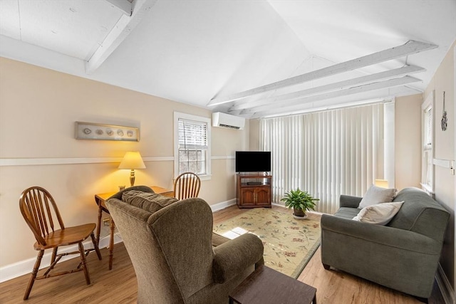 living room with lofted ceiling with beams, light wood-type flooring, baseboards, and an AC wall unit