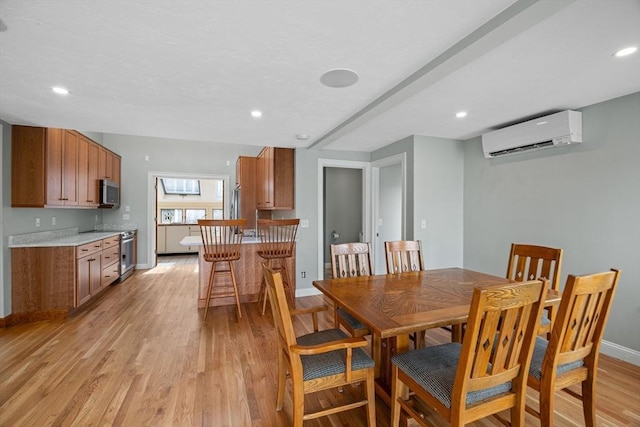 dining space featuring recessed lighting, a wall mounted air conditioner, light wood-type flooring, and baseboards