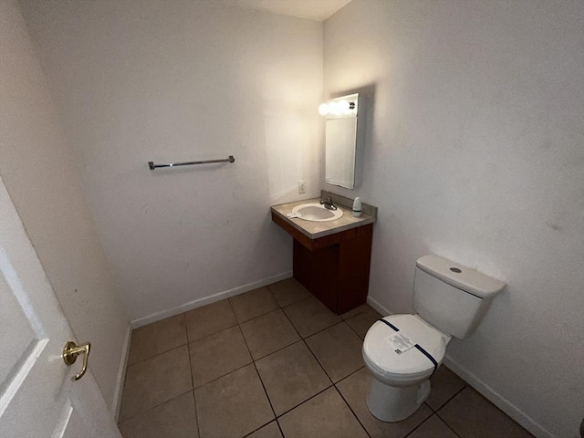 bathroom featuring vanity, tile patterned flooring, and toilet