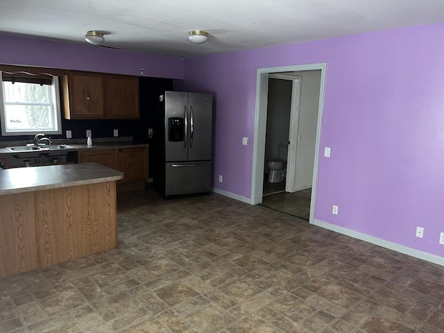 kitchen with stainless steel refrigerator with ice dispenser and sink