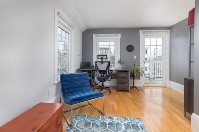 office space with wood finished floors, baseboards, and plenty of natural light