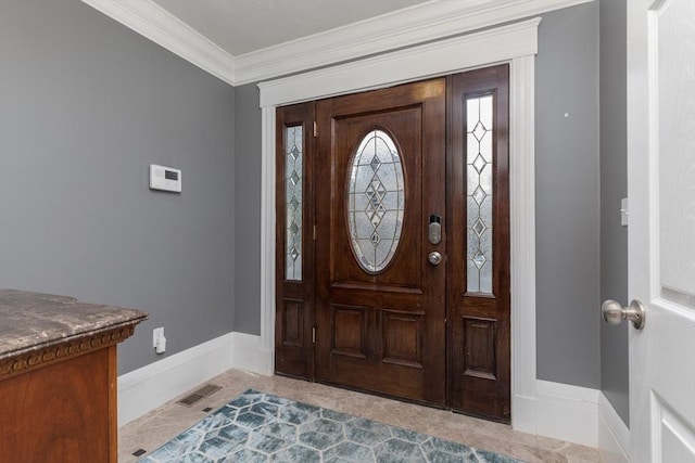 entrance foyer featuring baseboards, visible vents, and ornamental molding