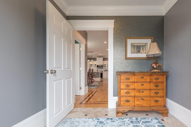 hall with crown molding and baseboards