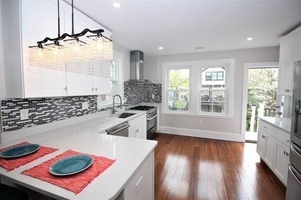 318 Concord Ave Unit 2, Cambridge, MA 02138 - kitchen featuring wall chimney exhaust hood, appliances with stainless steel finishes, a sink, plenty of natural light, and recessed lighting
