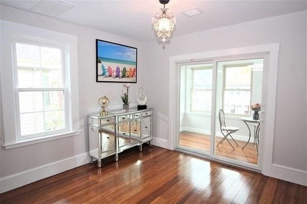 318 Concord Ave Unit 2, Cambridge, MA 02138 - doorway featuring a chandelier, healthy amount of natural light, and dark wood-type flooring