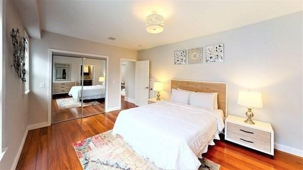 318 Concord Ave Unit 2, Cambridge, MA 02138 - bedroom featuring baseboards, wood finished floors, and a closet