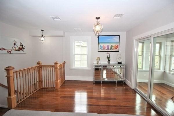 318 Concord Ave Unit 2, Cambridge, MA 02138 - dining space with wood finished floors, baseboards, and a chandelier