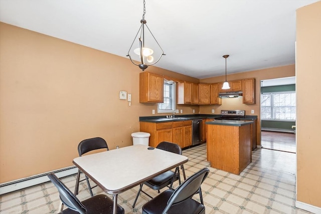 kitchen with light floors, a sink, stainless steel appliances, under cabinet range hood, and a baseboard heating unit