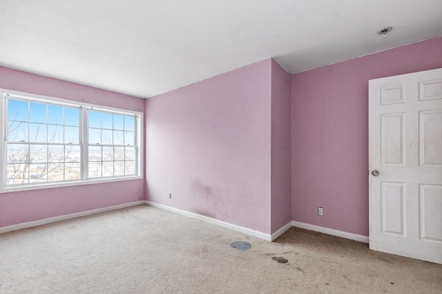 spare room with baseboards and carpet flooring