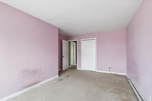 carpeted empty room with baseboards and baseboard heating