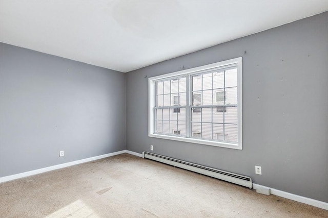 carpeted spare room with baseboards and baseboard heating