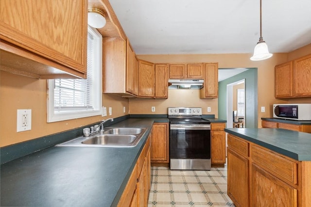 kitchen with electric range, under cabinet range hood, a sink, dark countertops, and light floors