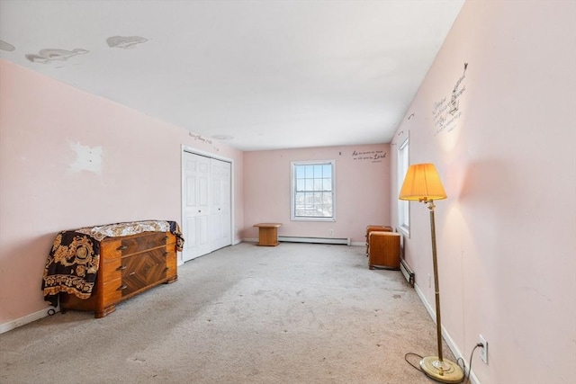 interior space featuring a closet, carpet floors, a baseboard radiator, baseboards, and baseboard heating