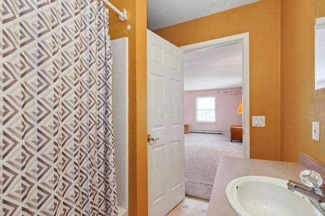 full bathroom featuring a shower with shower curtain, a baseboard radiator, and vanity