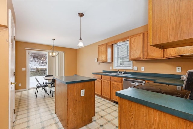 kitchen with dark countertops, light floors, a kitchen island, and stainless steel dishwasher